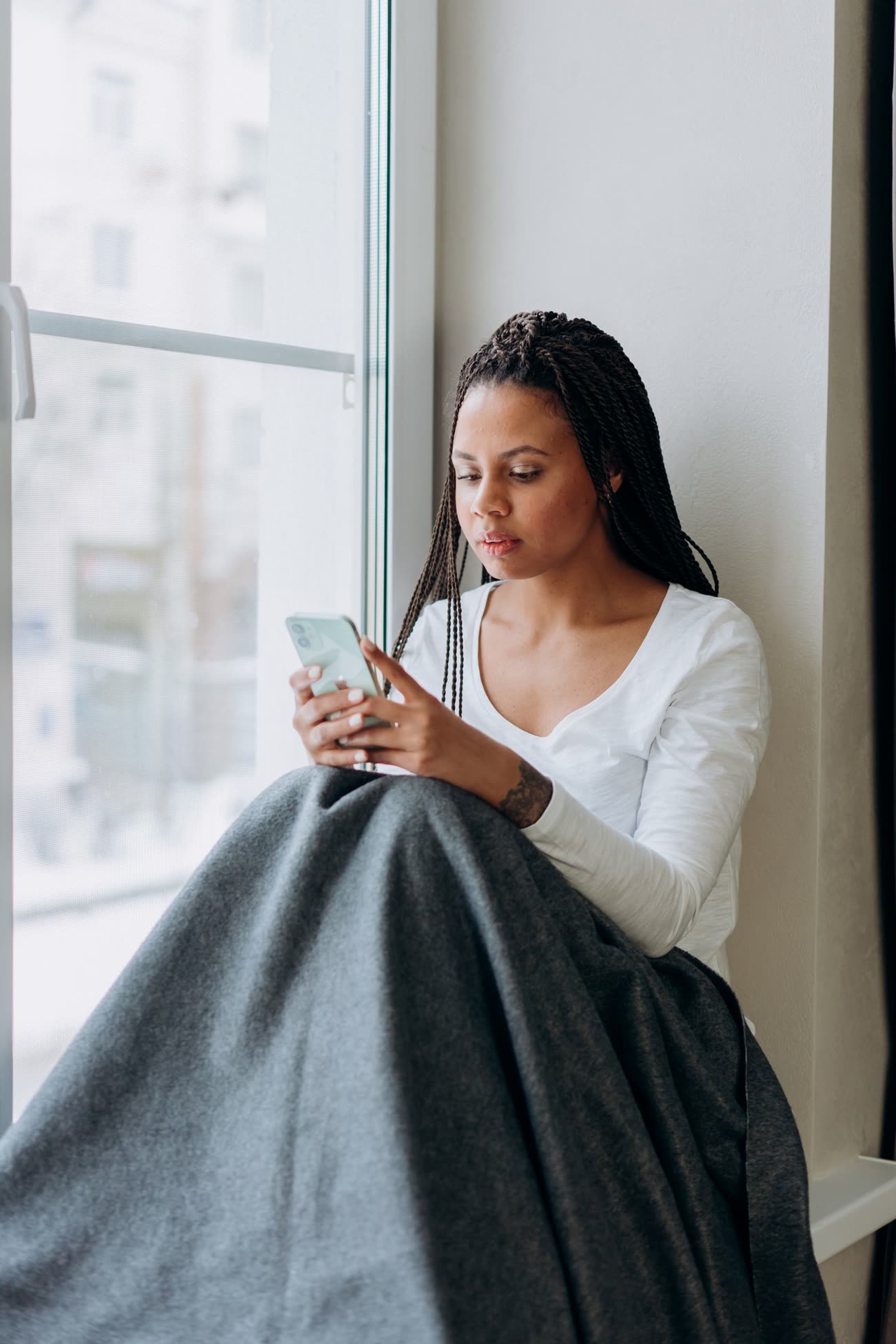A person reading on a phone in soft light